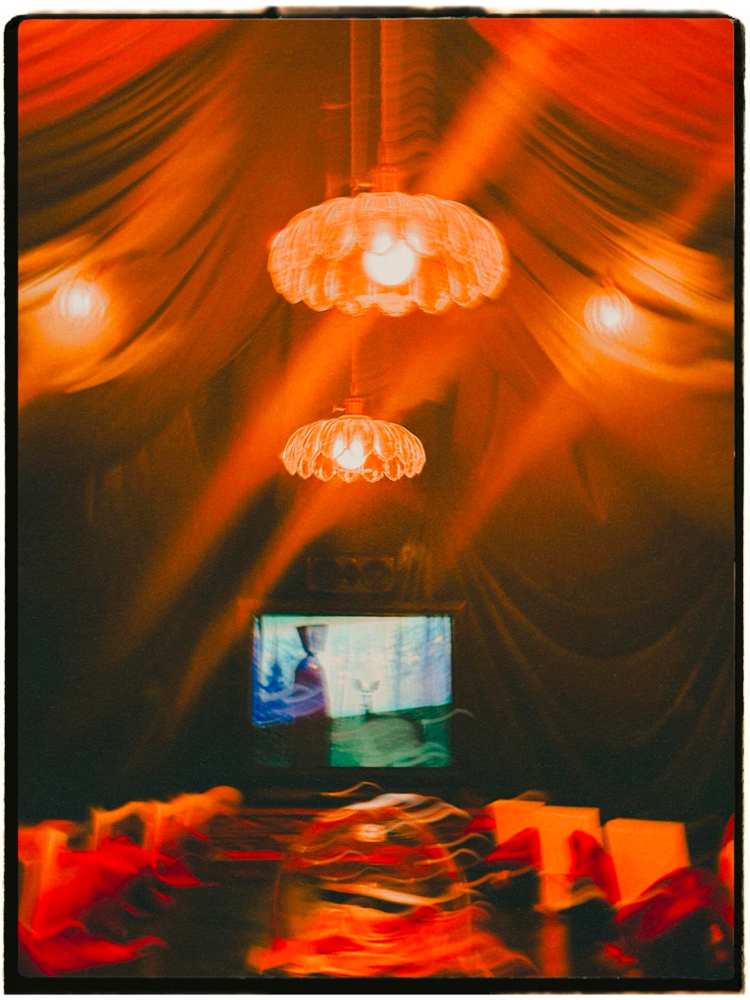 Lamps glow over the chamber's draped ceiling.
